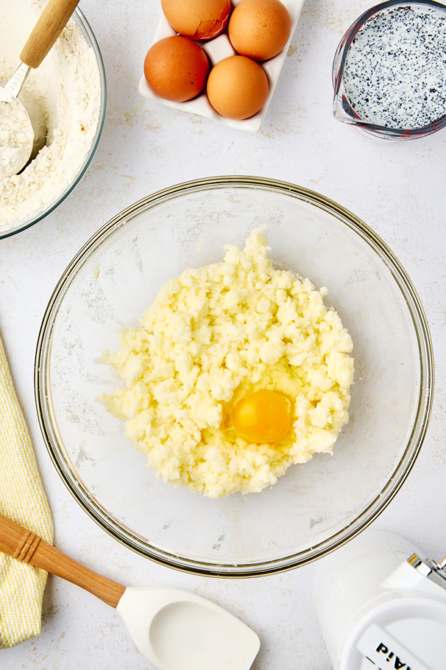 overhead view of egg added to creamed butter and sugar