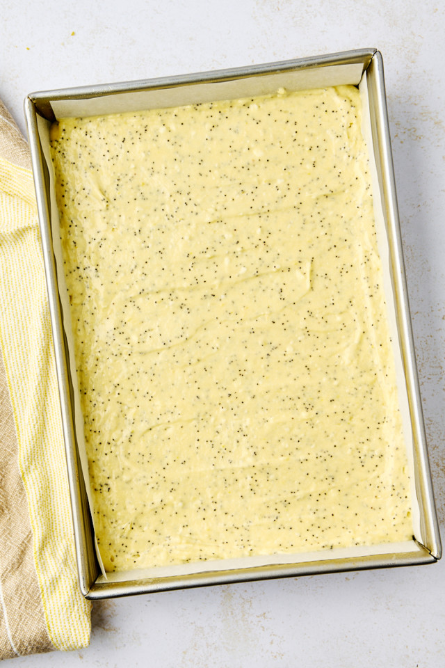 overhead view of lemon poppy seed cake batter in a 9x13 pan ready to go into the oven