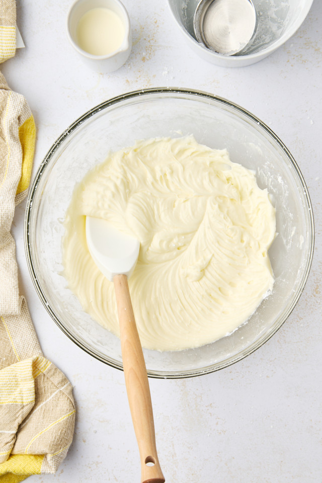 overhead view of lemon cream cheese frosting in a mixing bowl