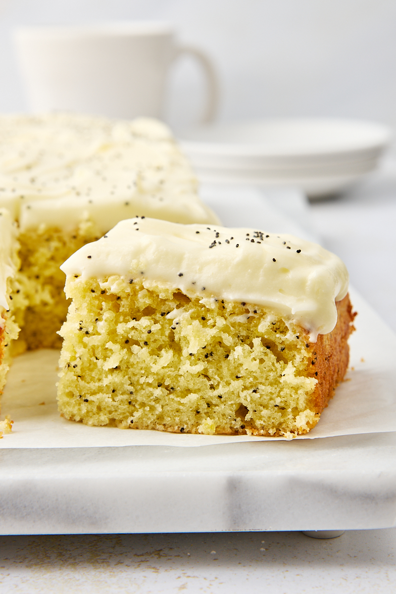 partially sliced lemon poppy seed cake on a marble serving tray