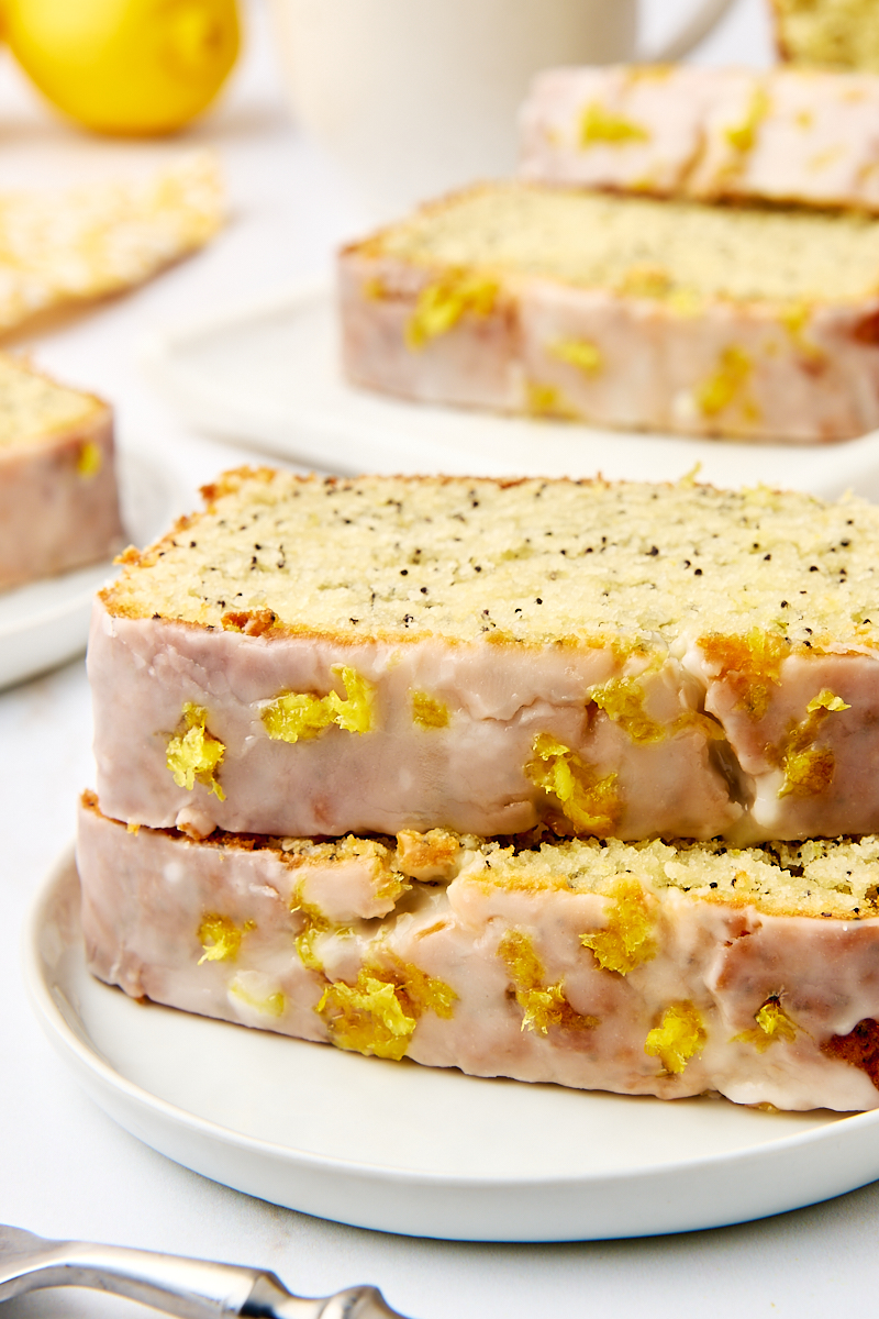 two stacked slices of lemon poppy seed loaf on a white plate