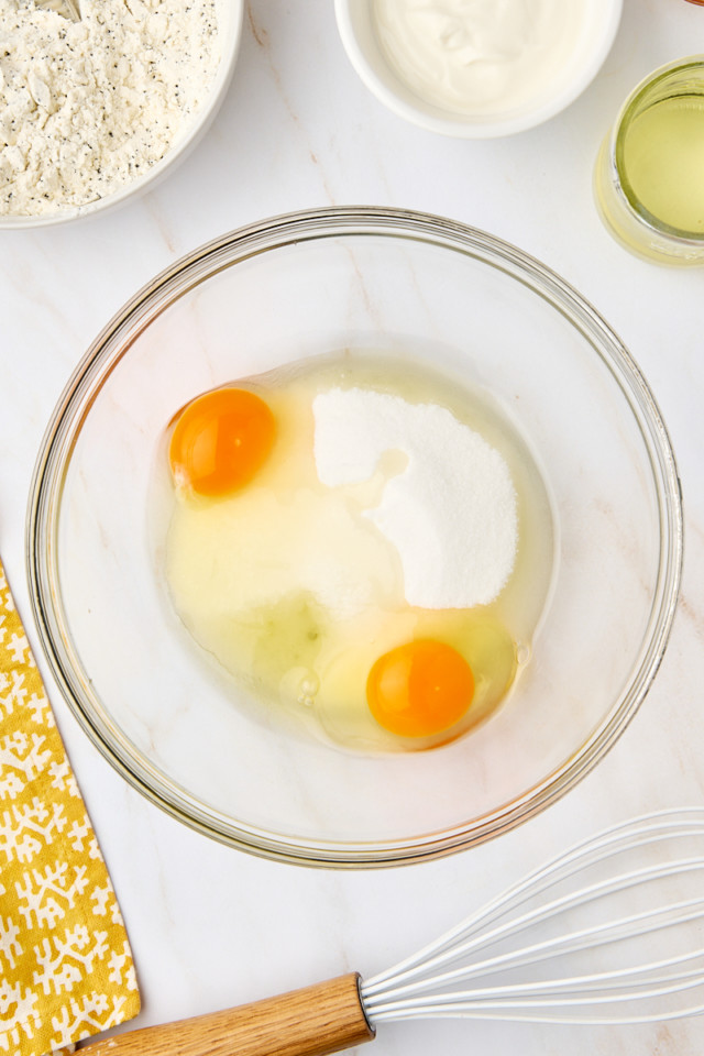 overhead view of sugar and eggs in a mixing bowl