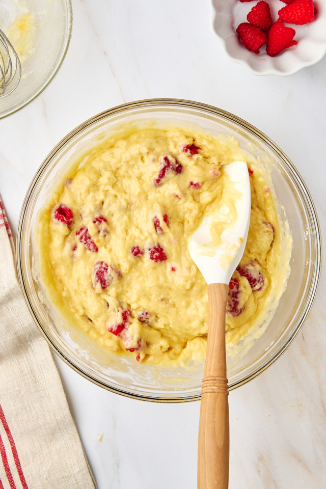 overhead view of lemon raspberry muffin batter in a mixing bowl