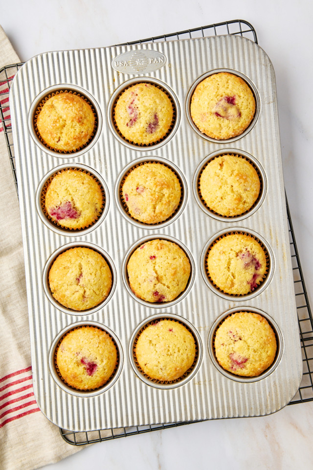 overhead view of freshly baked lemon raspberry muffins in a muffin pan