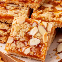 an apricot bar leaned against more bars on a wooden cutting board