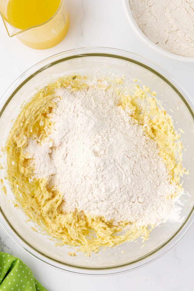 overhead view of dry ingredients added to wet ingredients for citrus cake