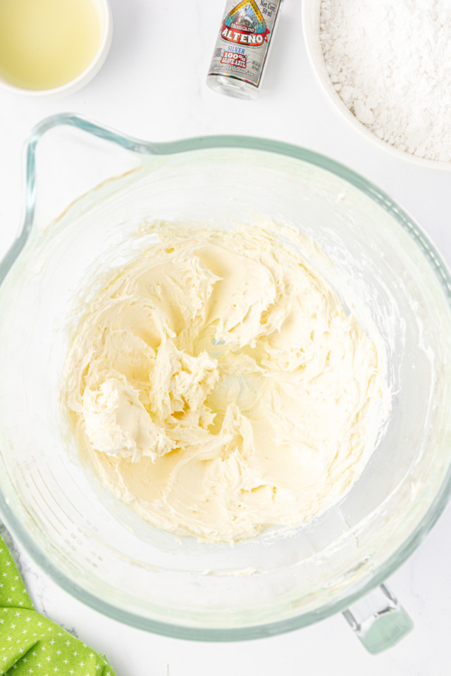 overhead view of beaten butter and cream cheese in a mixing bowl