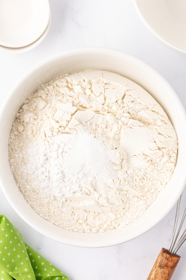 overhead view of cake flour, baking powder, and salt in a mixing bowl