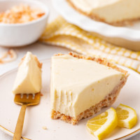 a slice of lemon icebox pie on a plate with a bite on a fork