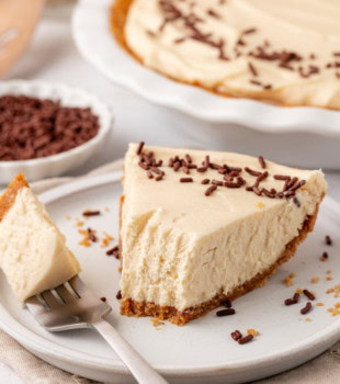 no-bake Bailey's cheesecake on a white plate with a bite on a fork