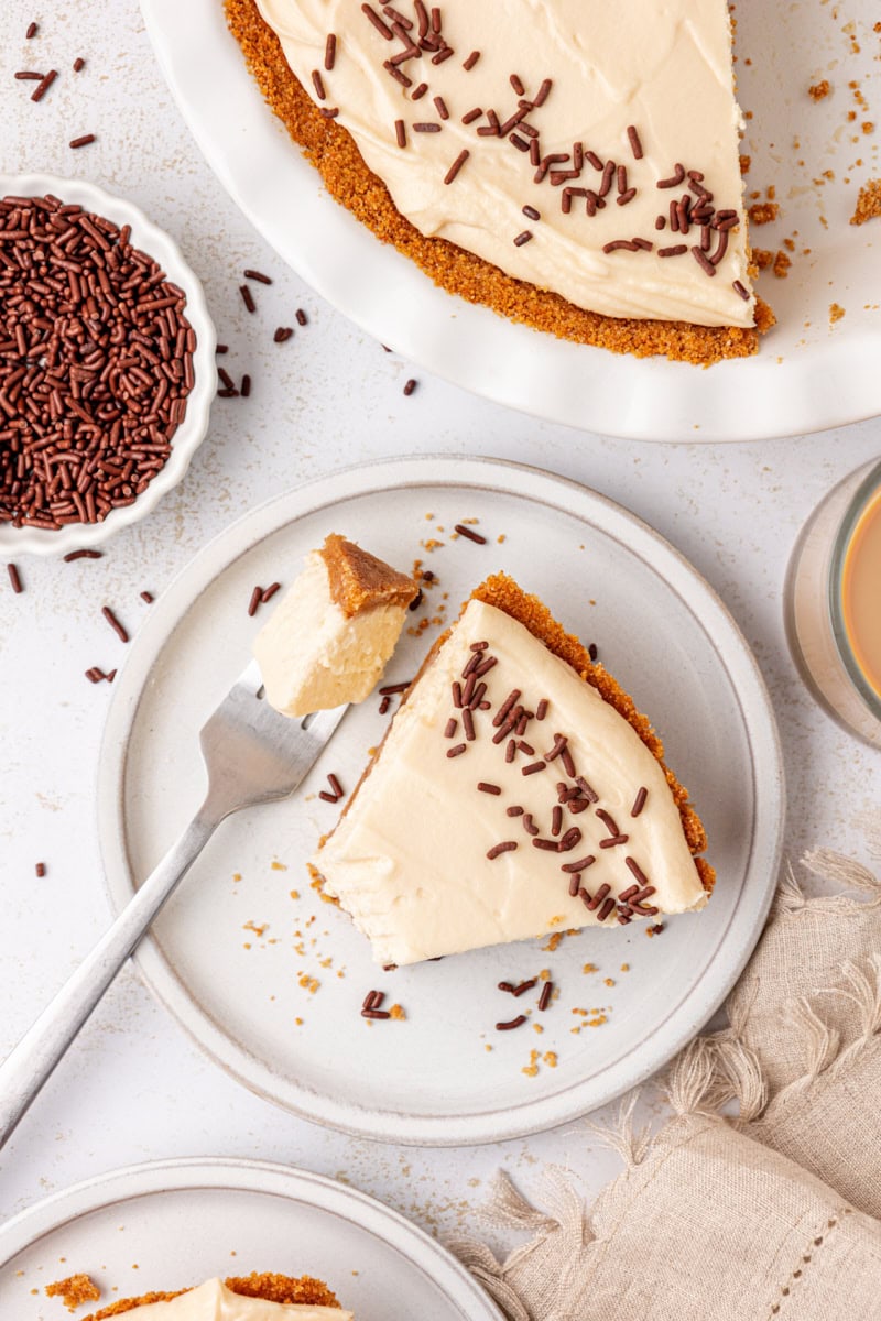 overhead view of a slice of no-bake Bailey's cheesecake on a plate with a bite on a fork