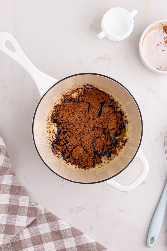 overhead view of cocoa powder, milk, and melted butter in a saucepan