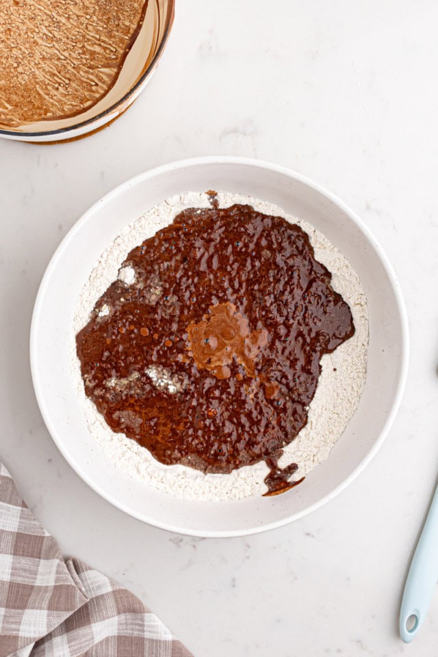 overhead view of chocolate mixture added to dry ingredients for Texas sheet cake