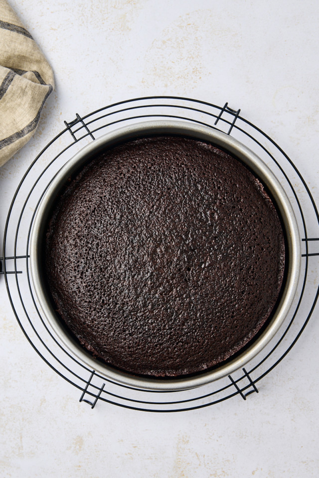 overhead view of freshly baked Guinness chocolate cake in a cake pan on a wire rack