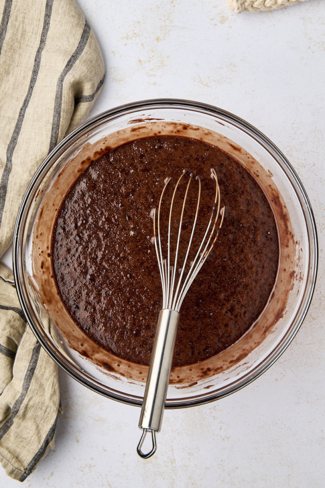 overhead view of Guinness chocolate cake batter in a glass mixing bowl