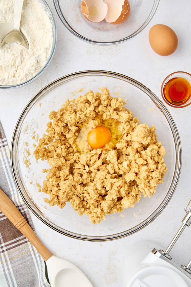 overhead view of egg added to creamed butter and brown sugar