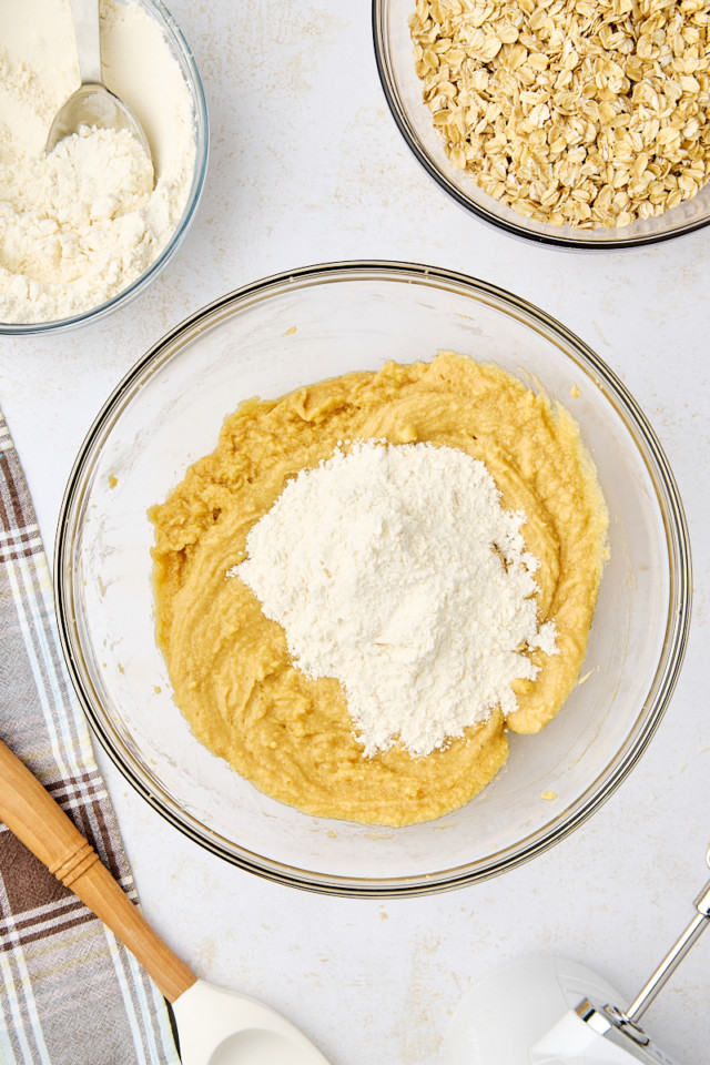 overhead view of flour mixture added to butter mixture for revel bars