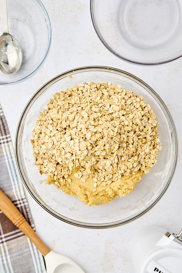 overhead view of oats added to revel bars dough