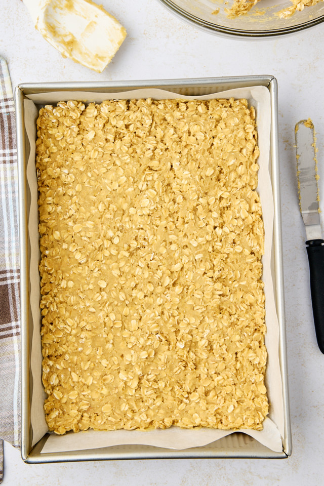 overhead view of the base layer of revel bars spread in a 9x13 pan