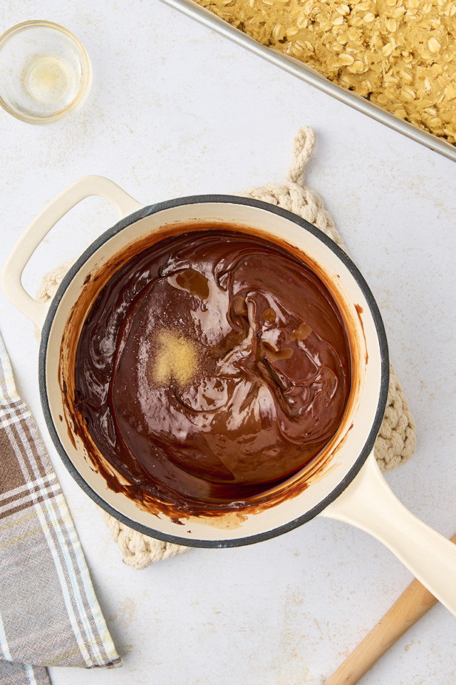 overhead view of vanilla and salt added to chocolate mixture for revel bars