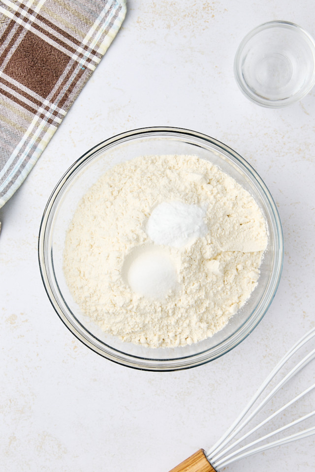 overhead view of flour, baking soda, and salt in a mixing bowl