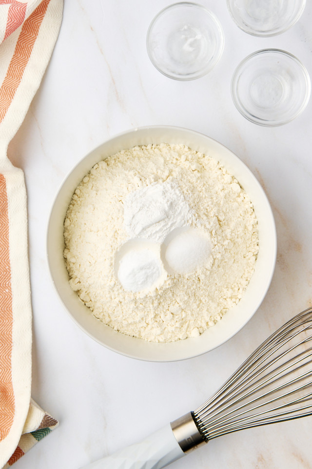 overhead view of flour, baking powder, baking soda, and salt in a bowl