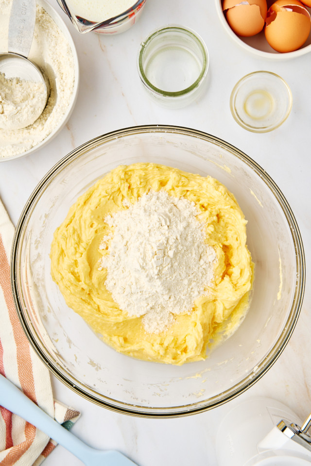 overhead view of dry ingredients added to wet ingredients for classic yellow cake