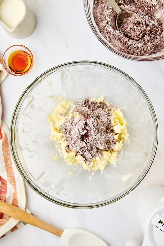 overhead view of confectioners' sugar, cocoa powder, and salt added to creamed butter