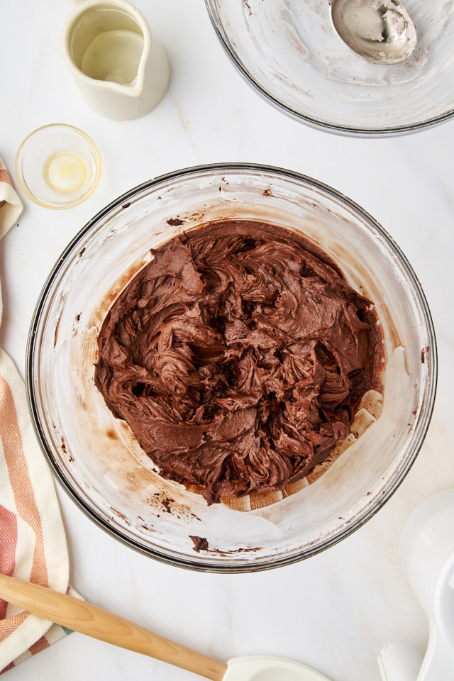 overhead view of chocolate buttercream frosting in a mixing bowl