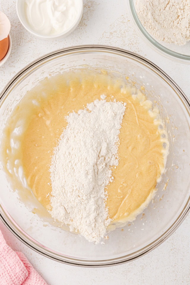 overhead view of dry ingredients added to wet ingredients for berry swirl pound cake
