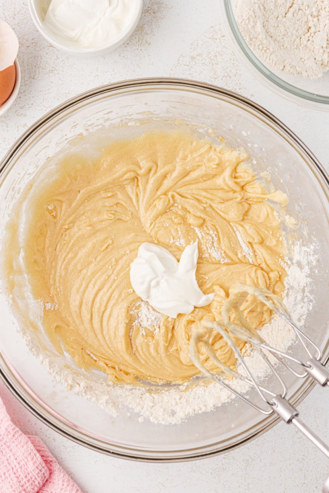 overhead view of sour cream added to berry swirl pound cake batter