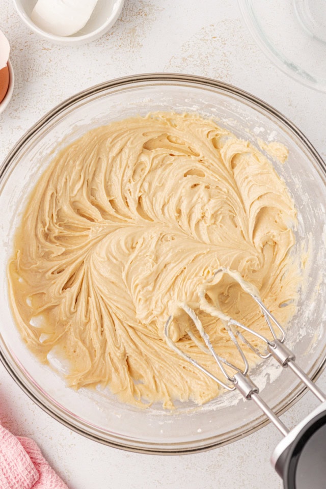 overhead view of berry swirl pound cake batter in a glass mixing bowl