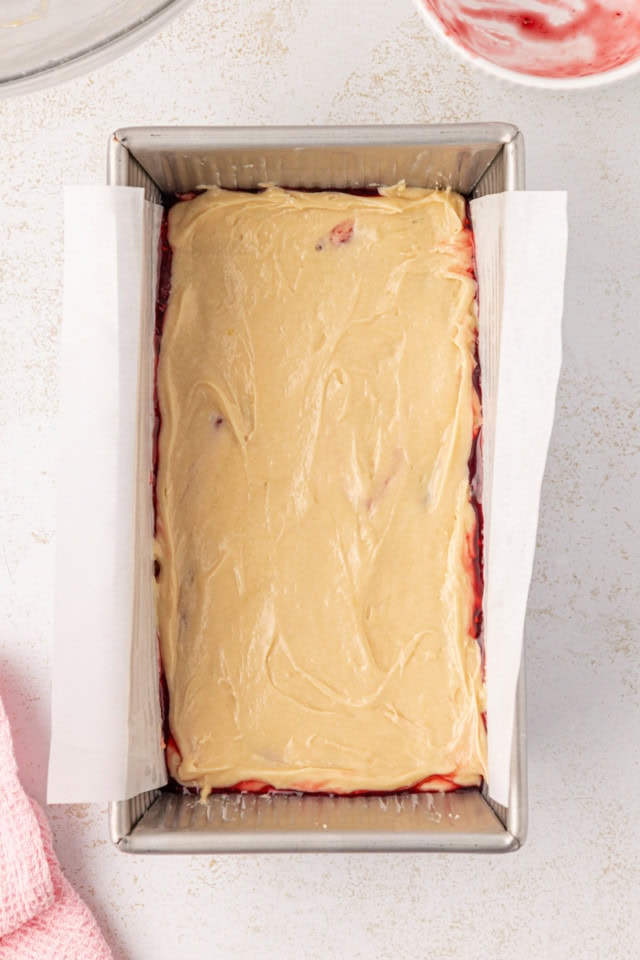 overhead view of berry swirl pound cake in a loaf pan ready to go into the oven