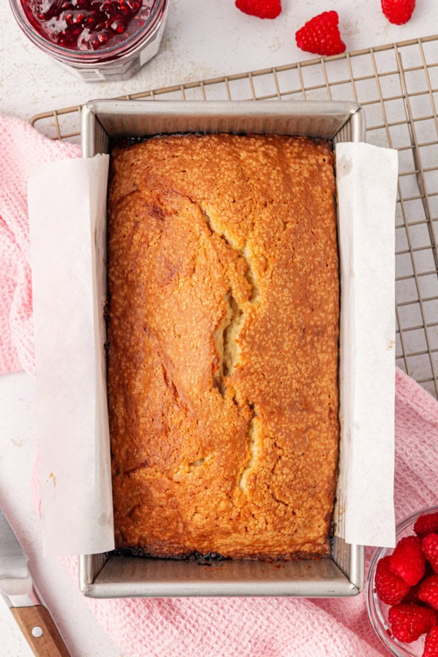 overhead view of freshly baked berry swirl pound cake in a loaf pan on a wire rack