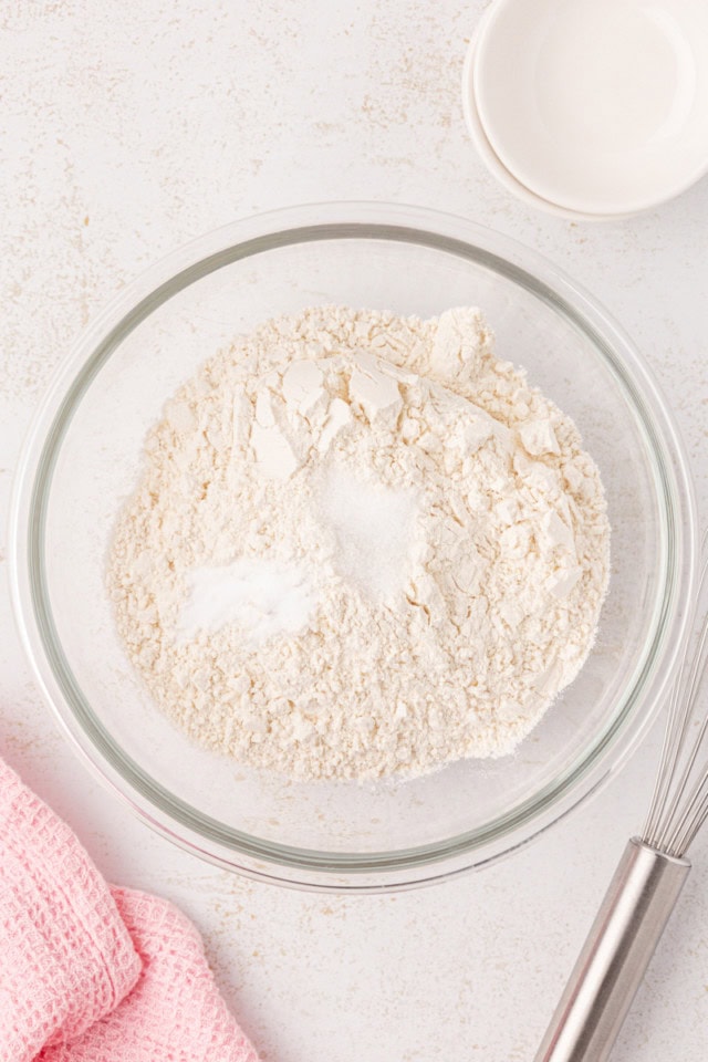 overhead view of flour, baking soda, and salt in a glass mixing bowl