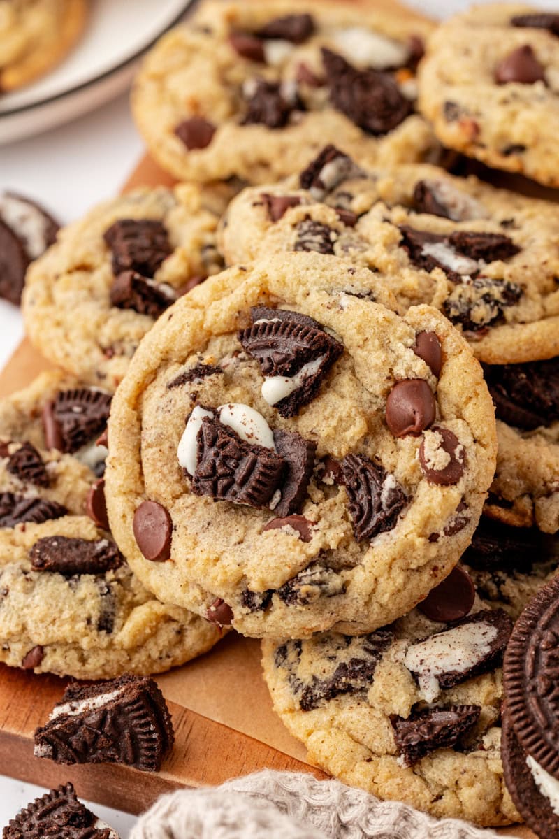 Oreo chocolate chip cookies piled on a wooden board