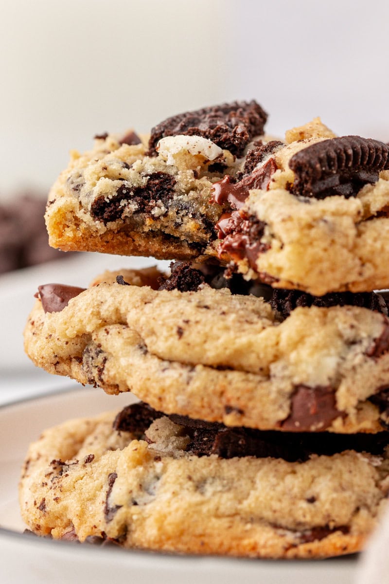 close-up of three stacked Oreo chocolate chip cookies with a bite missing from the top cookies