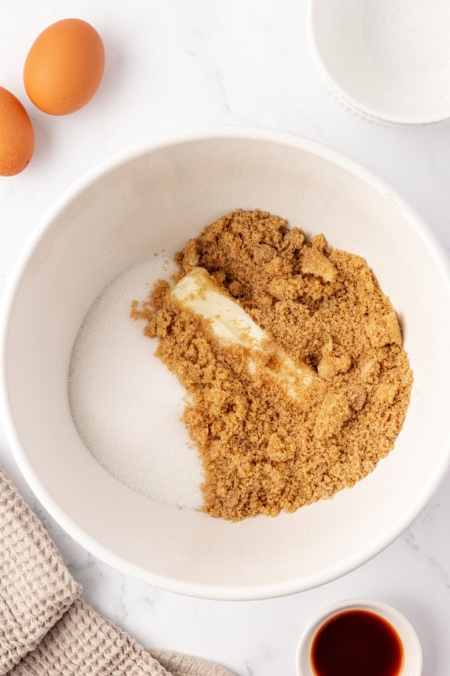 overhead view of butter, sugar, and brown sugar in a mixing bowl
