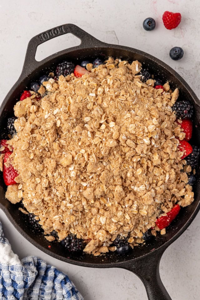 overhead view of skillet berry crisp ready to go into the oven