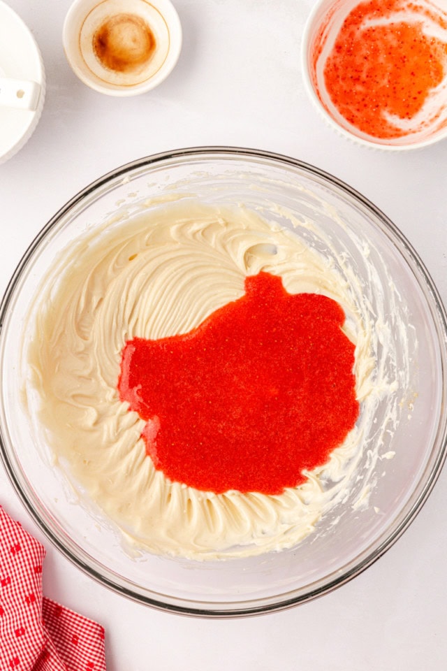 overhead view of pureed strawberries added to sweetened cream cheese mixture