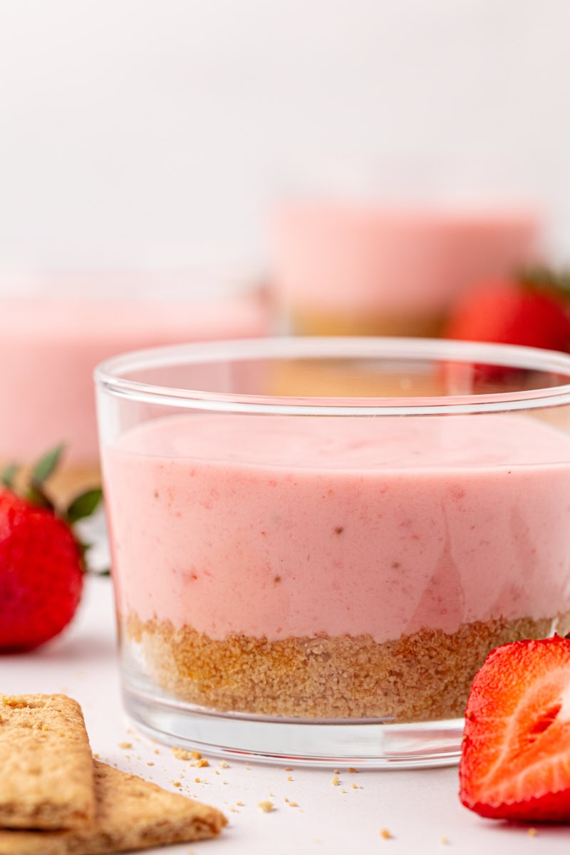 close-up of a strawberry no-bake cheesecake with more cheesecakes partially visible in the background