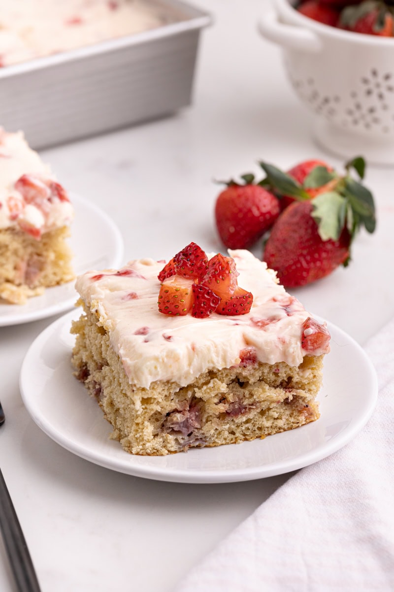 a slice of strawberry sheet cake on a white plate