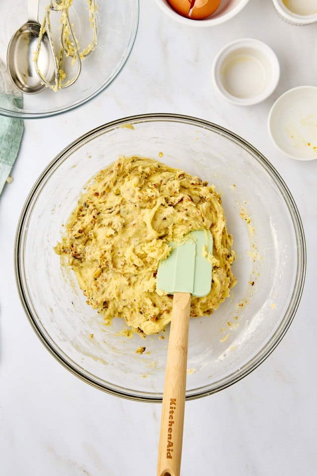 overhead view of pistachio biscotti dough in a glass mixing bowl