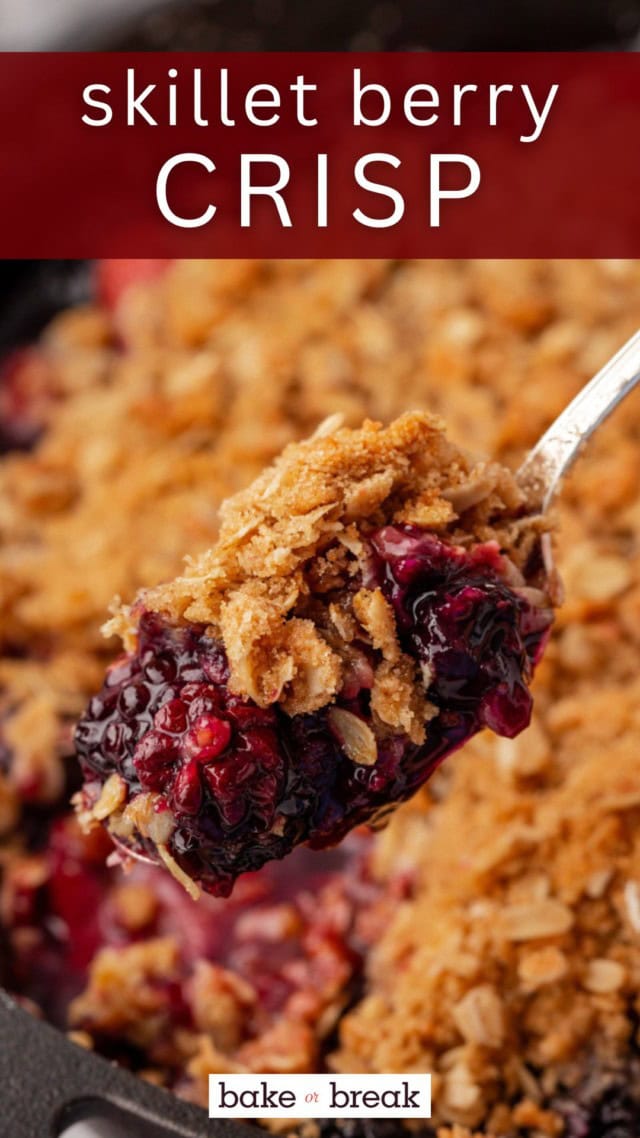 a spoonful of berry crisp with the remaining crisp in a skillet in the background; text overlay "skillet berry crisp"