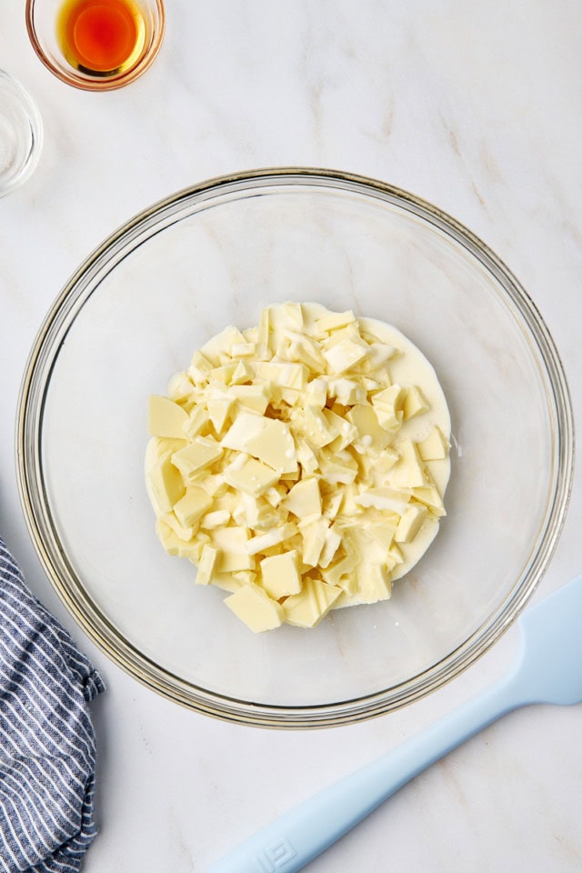 overhead view of white chocolate and heavy cream in a glass bowl