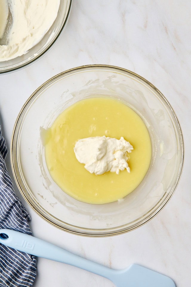 overhead view of whipped cream added to melted white chocolate