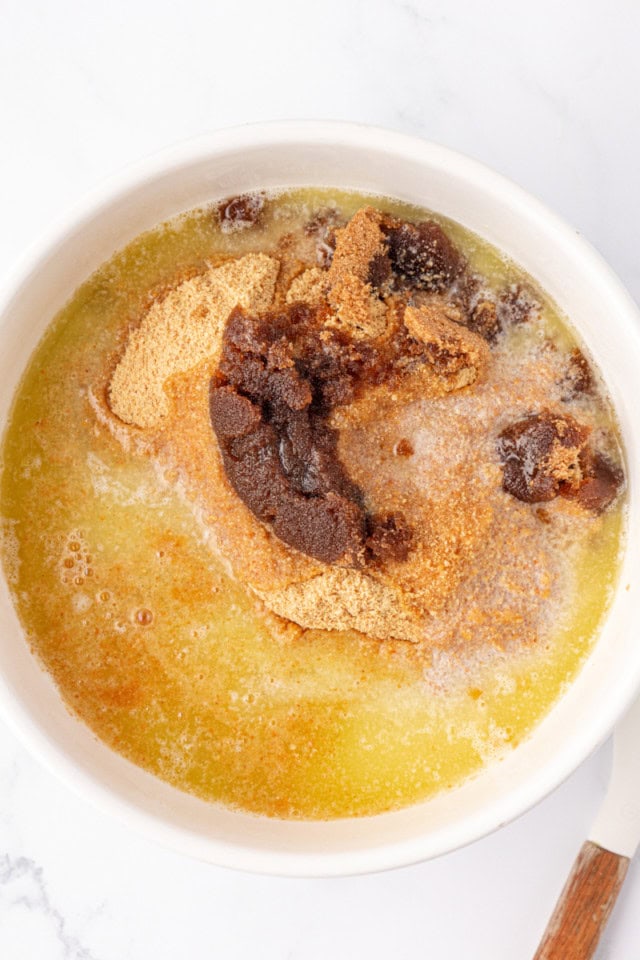 overhead view of graham crackers, brown sugar, and melted butter in a mixing bowl