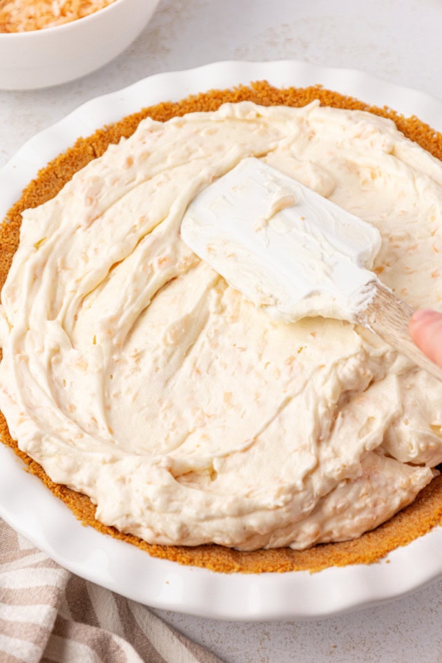 no-bake coconut cheesecake spread in a vanilla wafer crust in a pie pan