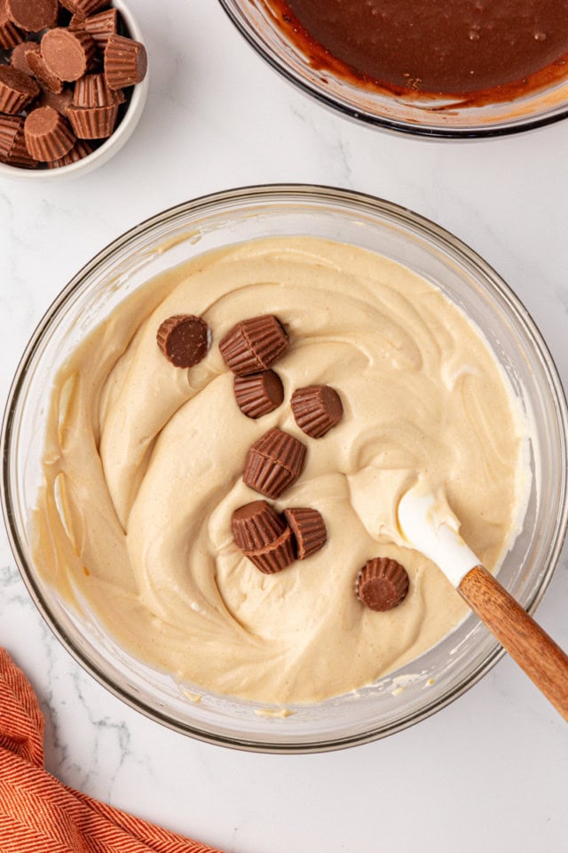 overhead view of mini peanut butter cups added to peanut butter ice cream