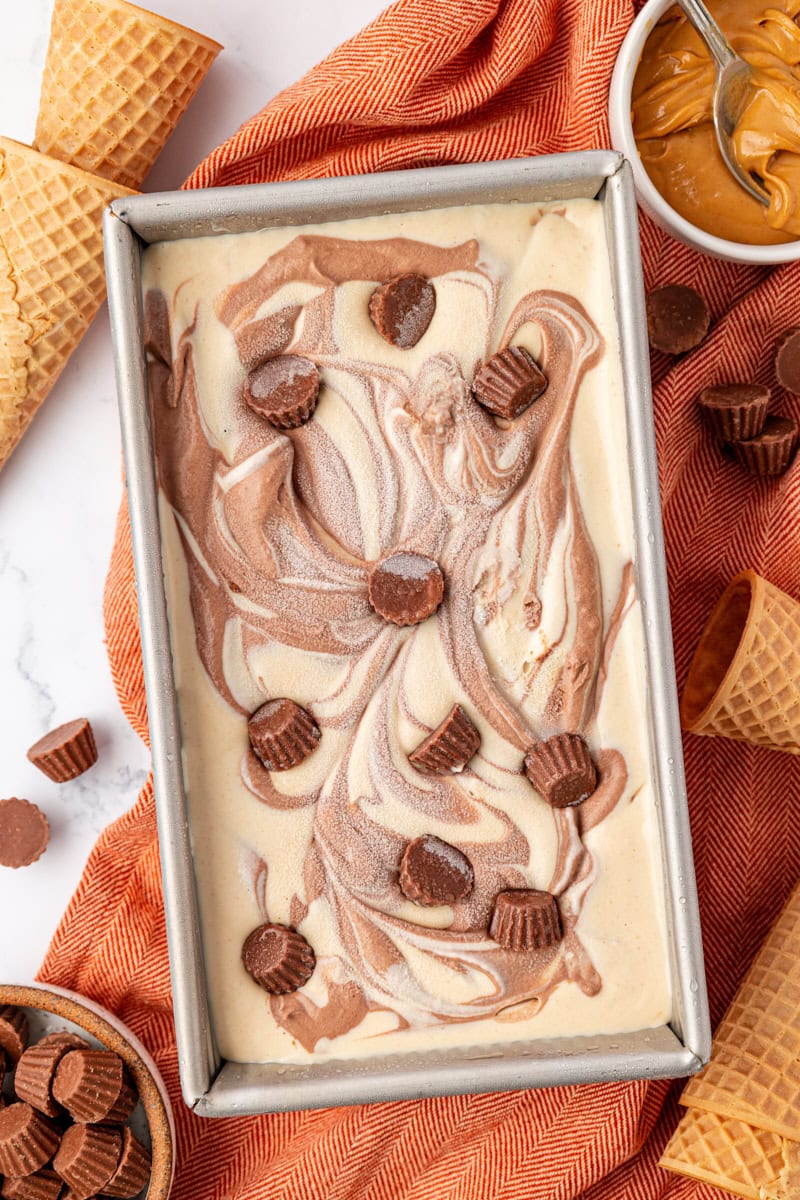 overhead view of no-churn chocolate peanut butter ice cream in a metal loaf pan after being frozen and set